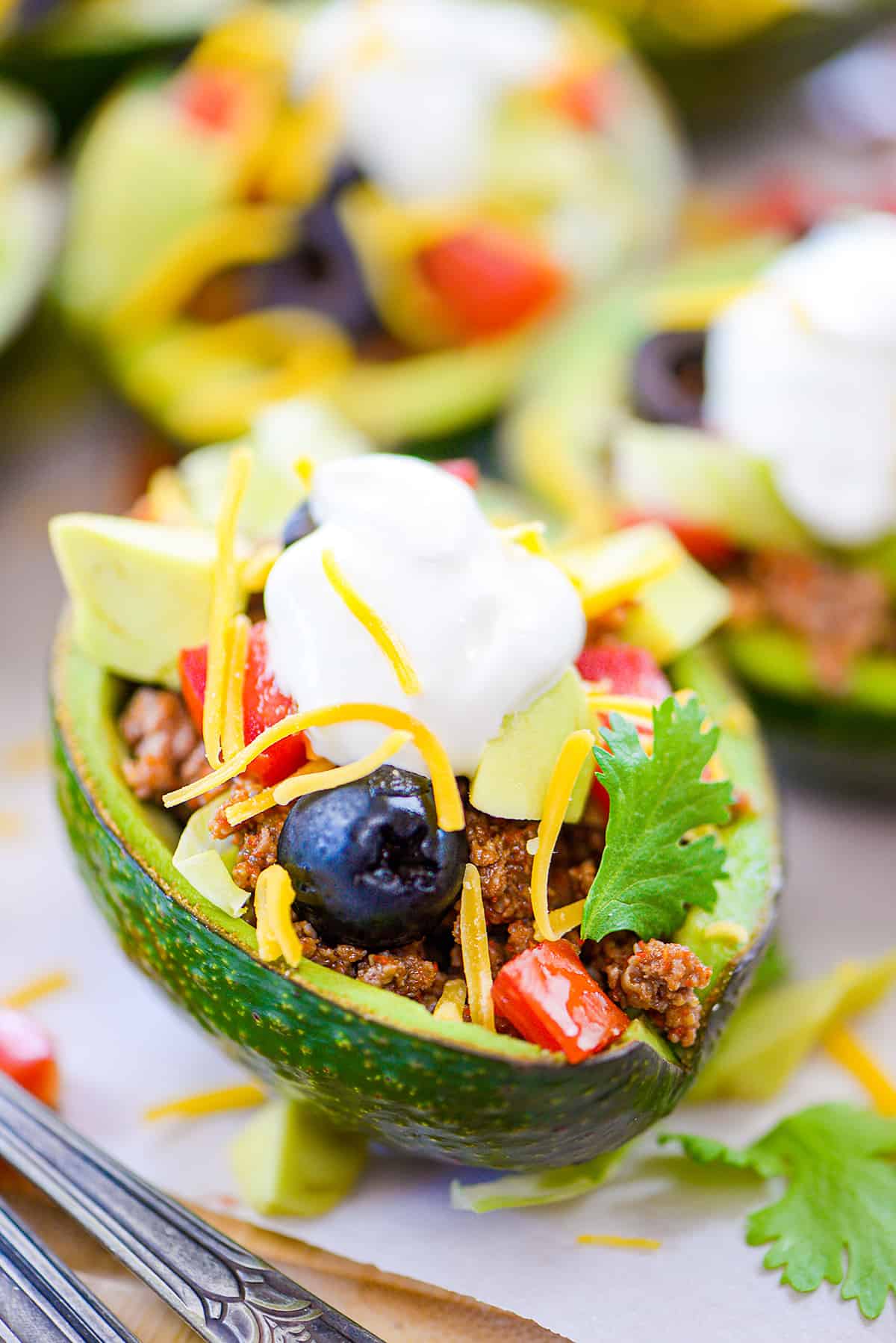 Avocado stuffed with taco meat and toppings.