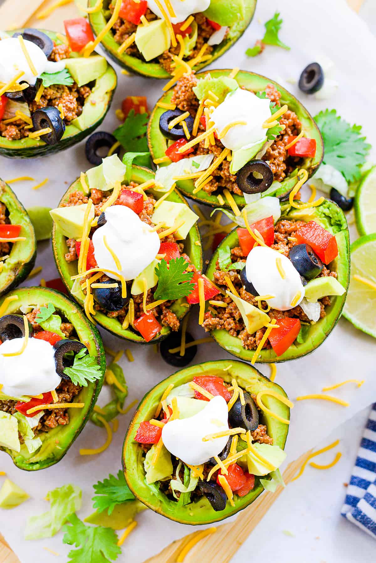 Overhead view of taco stuffed avocados on plate.