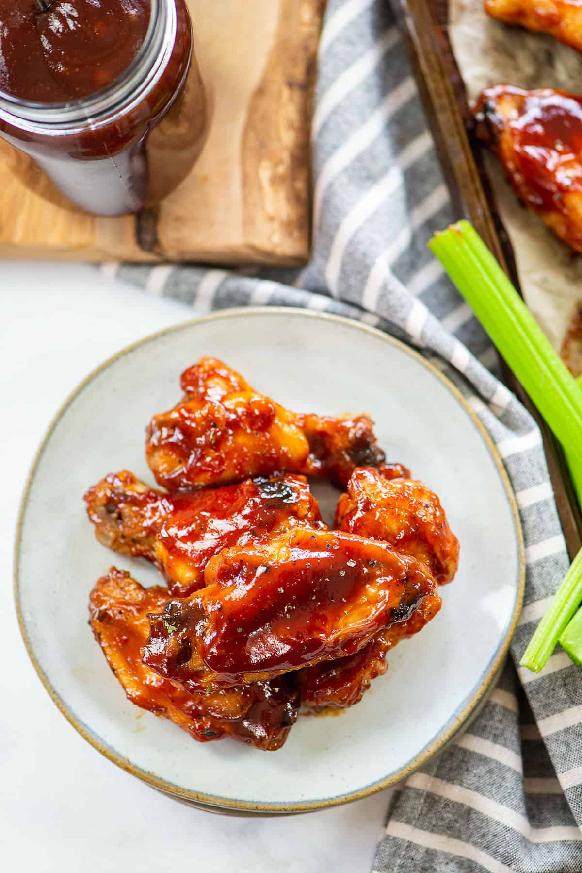 Baked BBQ chicken wings on plate.