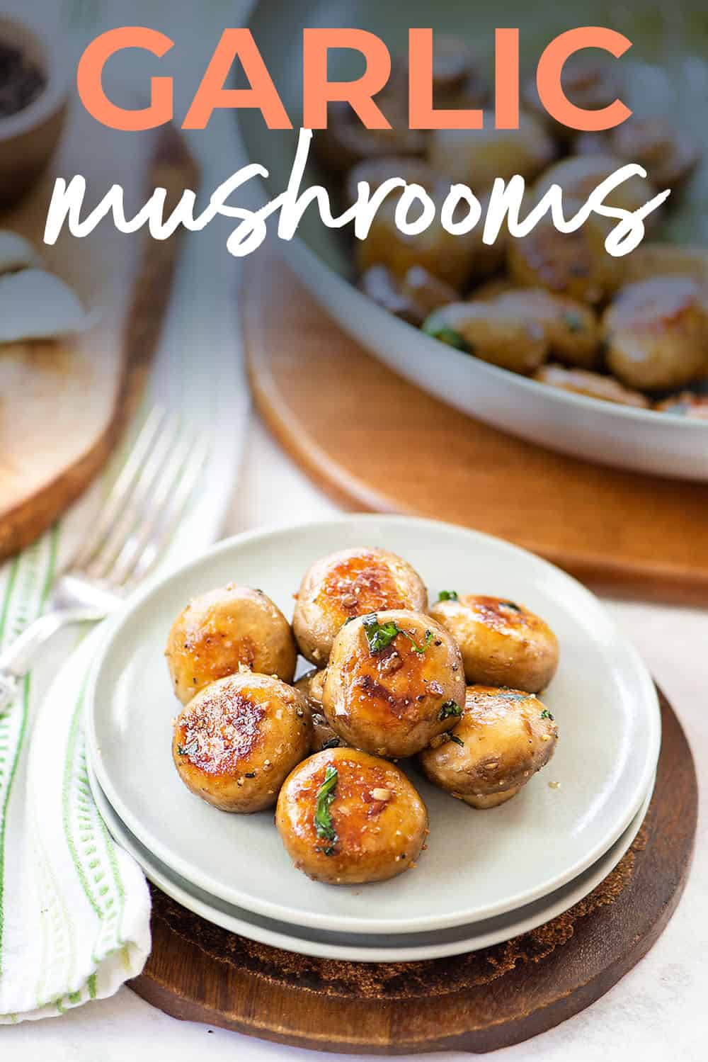 garlic mushrooms on plate with text for Pinterest.