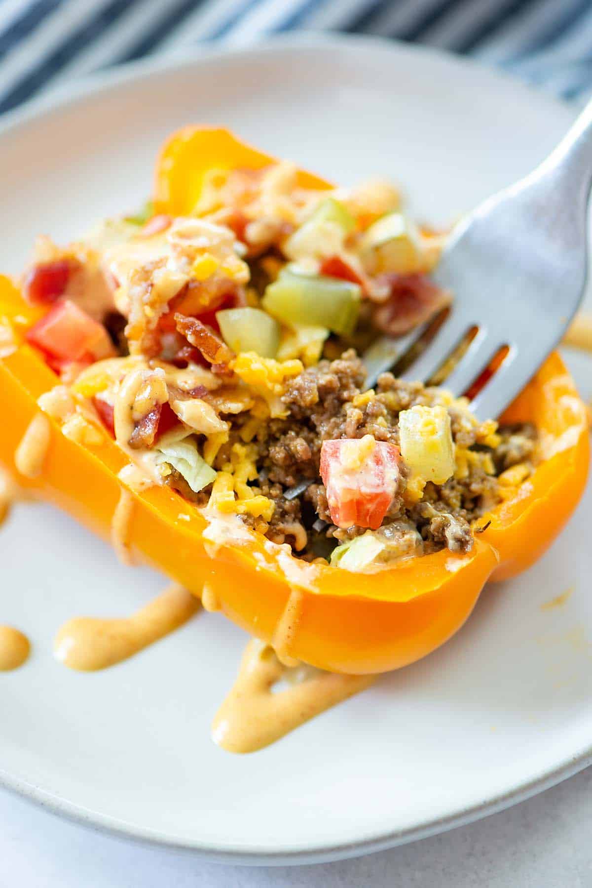 pepper stuffed with cheeseburger filling being eaten.