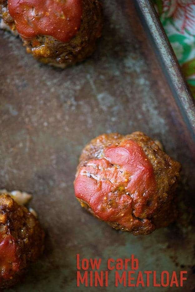 Three low carb mini meatloafs on a baking sheet.