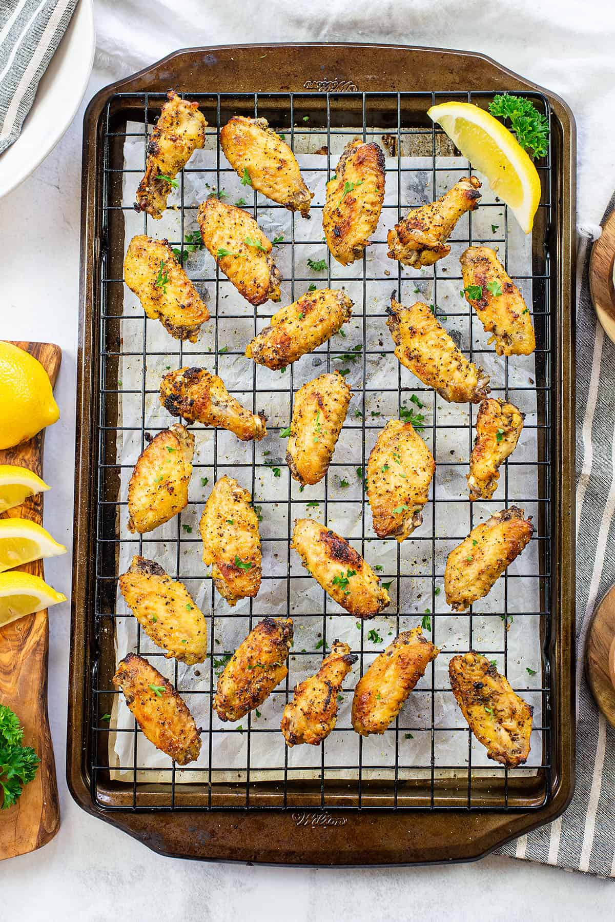 baked lemon pepper chicken wings on sheet pan.