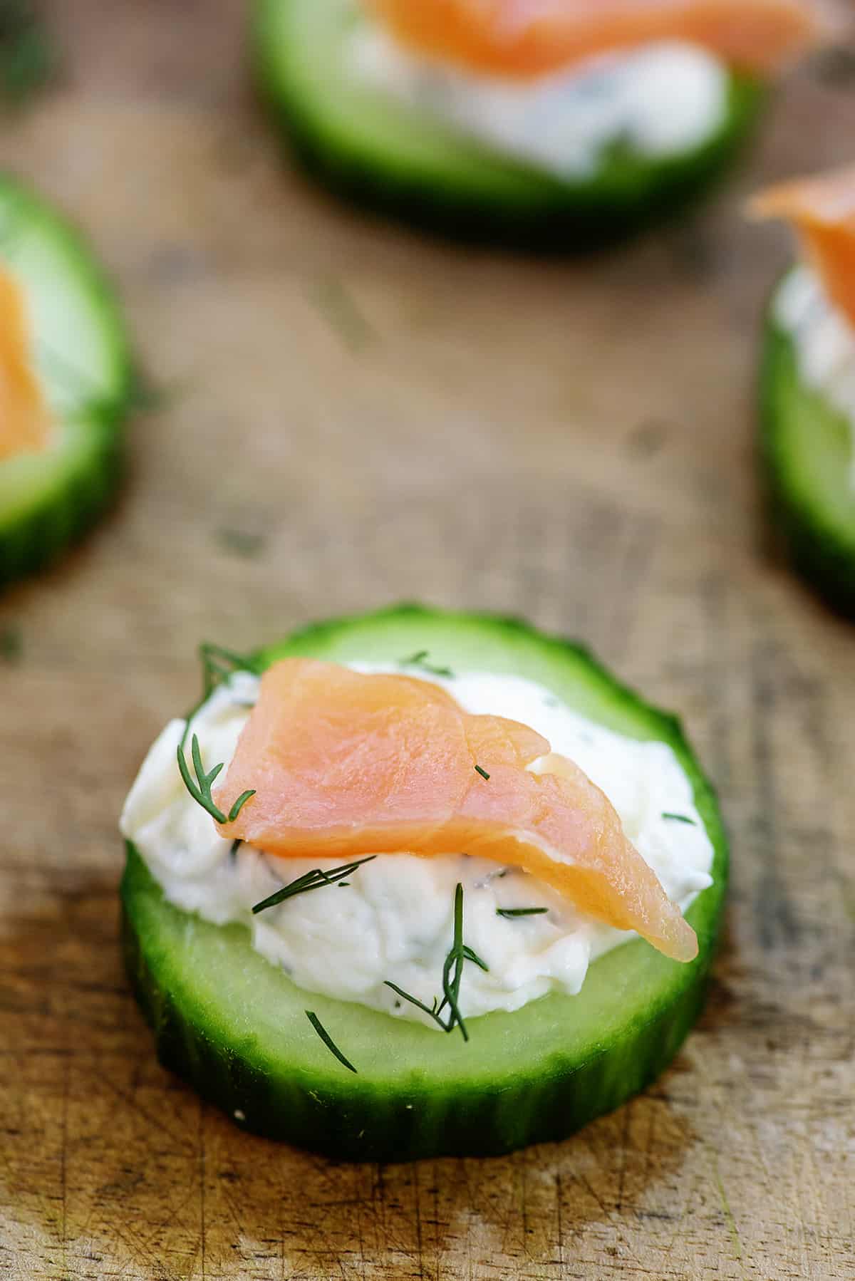 cucumber salmon bites on cutting board.