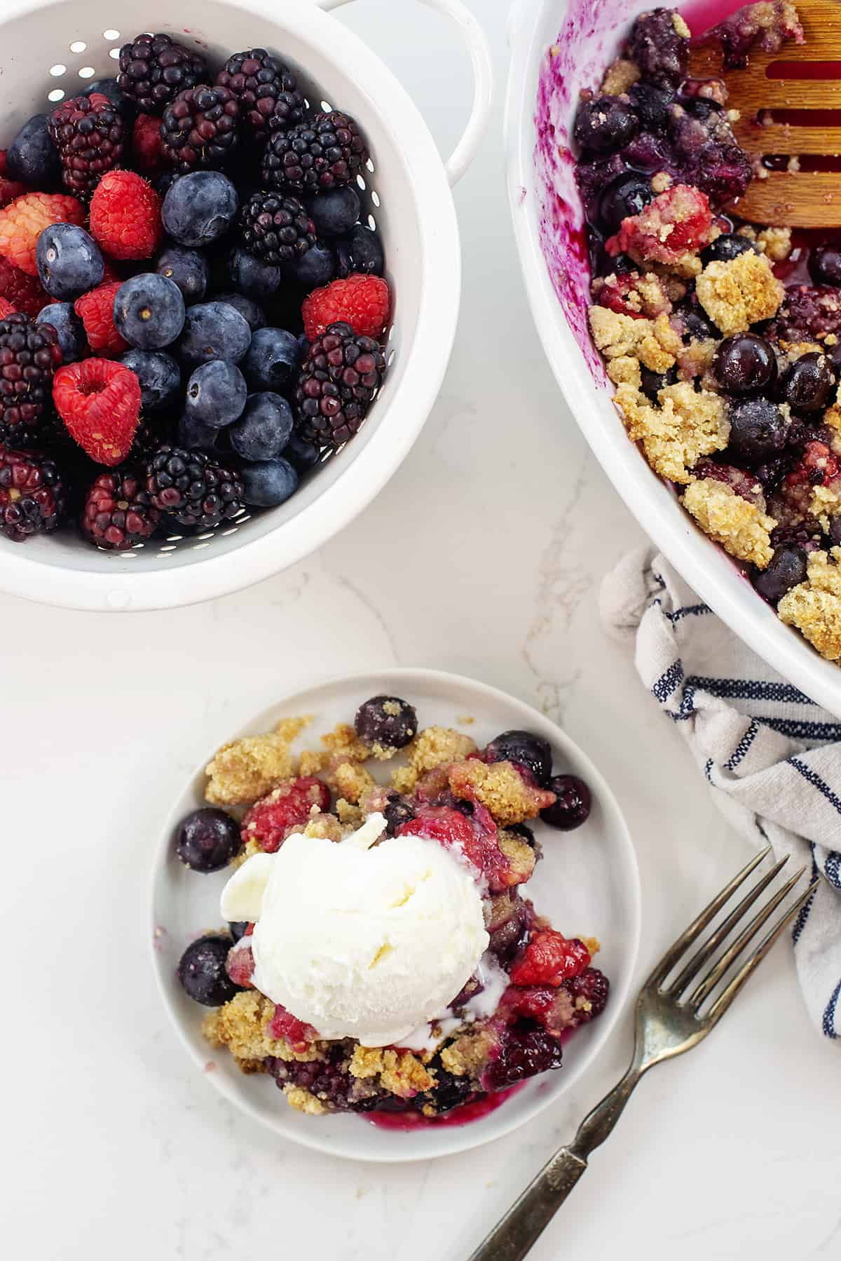Overhead view of keto berry crisp on plate with ice cream.