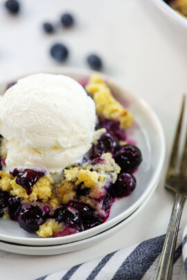 blueberry cobbler on small white plate.