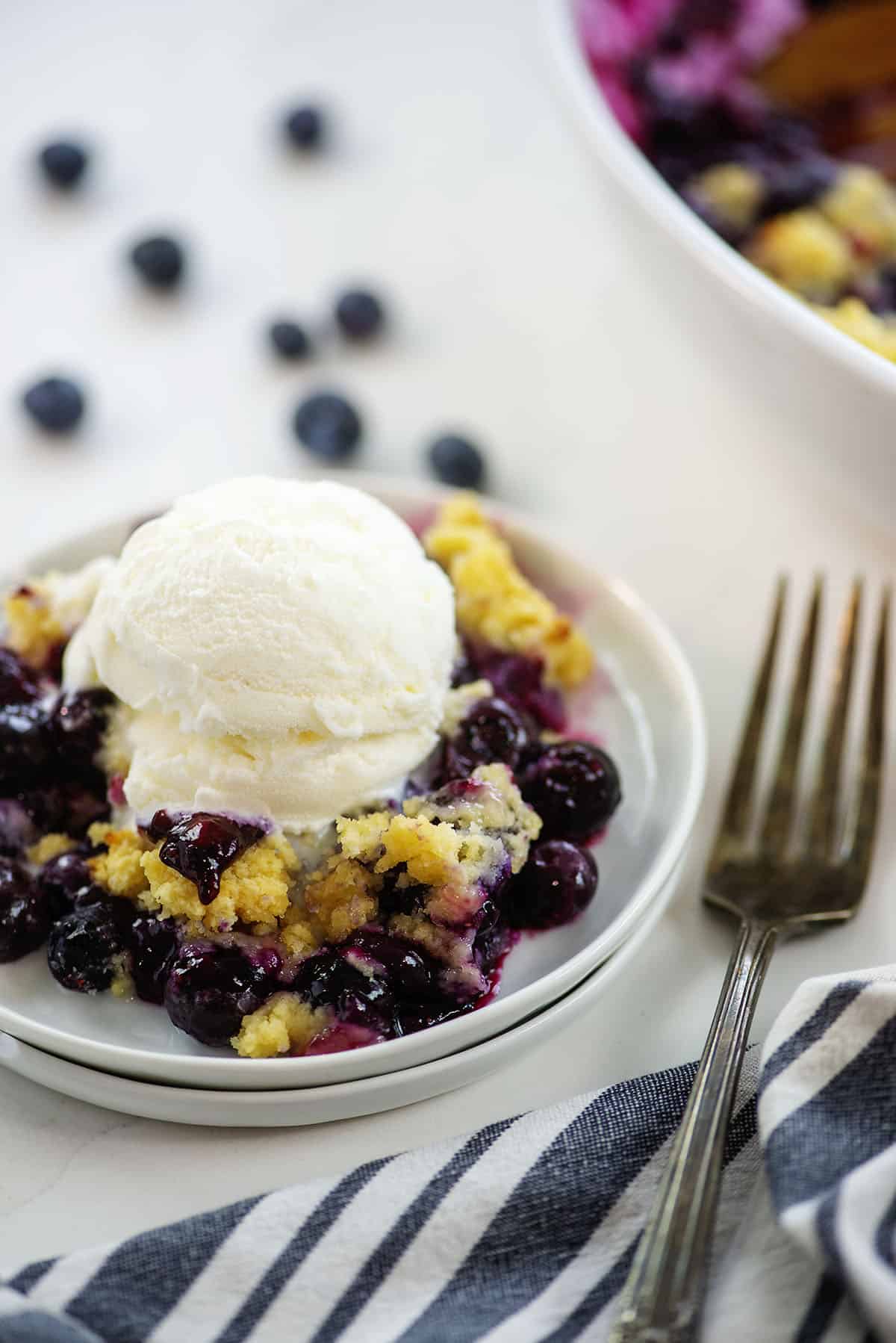 keto blueberry cobbler with scoop of vanilla ice cream on top.