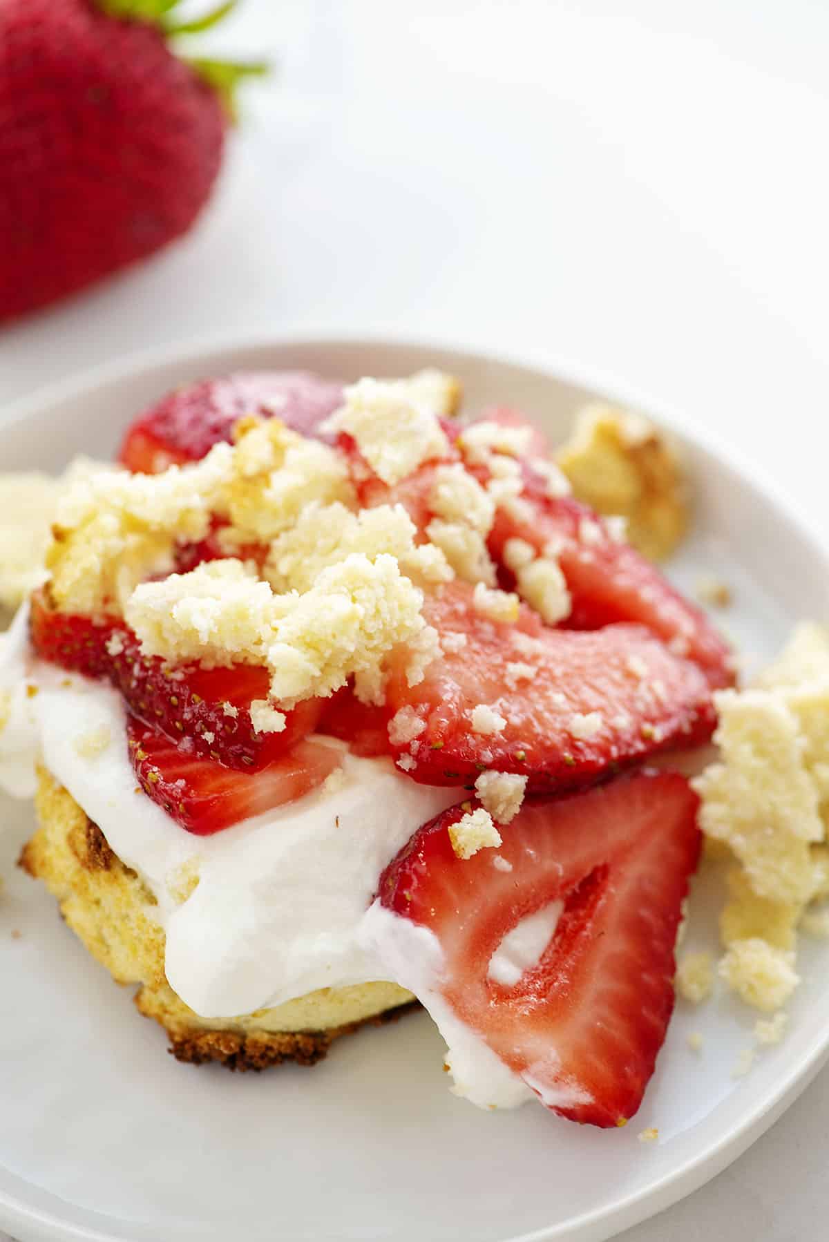 biscuit crumbled on top of strawberry shortcake.