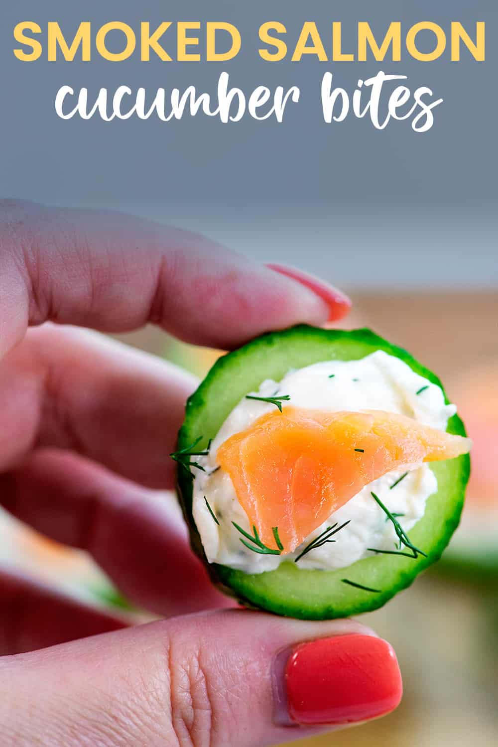 hand holding a cucumber salmon bite.