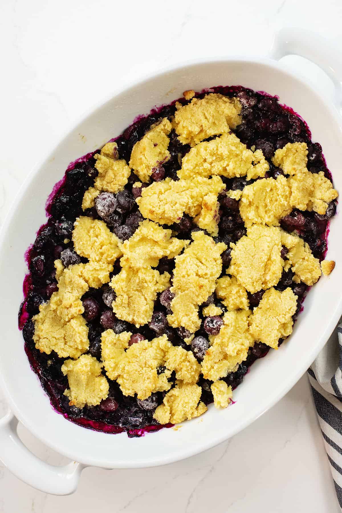 keto blueberry cobbler in white baking dish.