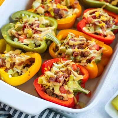 stuffed peppers in white baking dish.