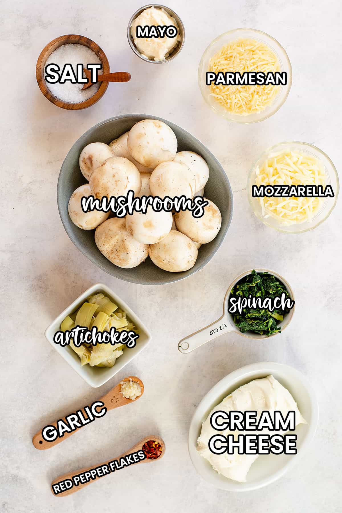 ingredients for spinach stuffed mushrooms on countertop.