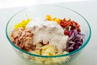 salad in bowl with dressing on top.
