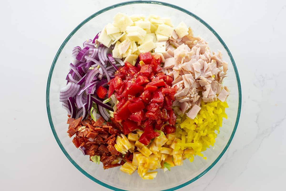 ingredients for grinder salad in mixing bowl.