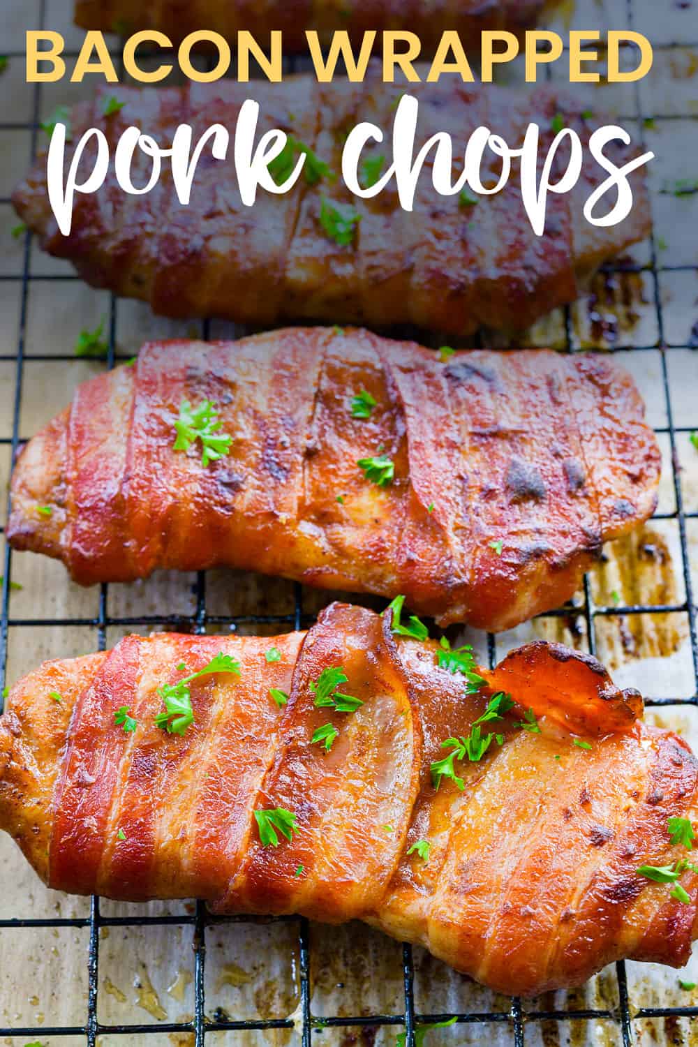 Bacon wrapped pork chops on wire rack.