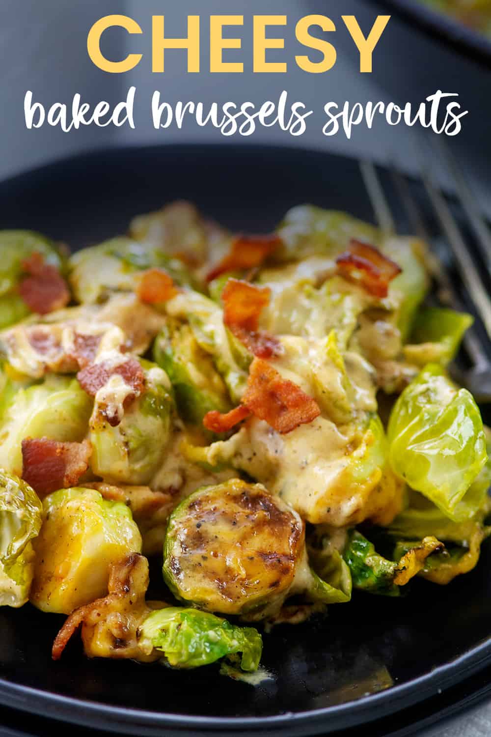 Black plate full of cheesy brussel sprouts.