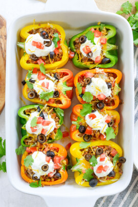 overhead view of taco stuffed peppers in white baking dish.