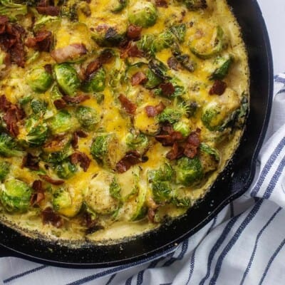 Overhead view of brussels sprouts casserole in cast iron skillet.