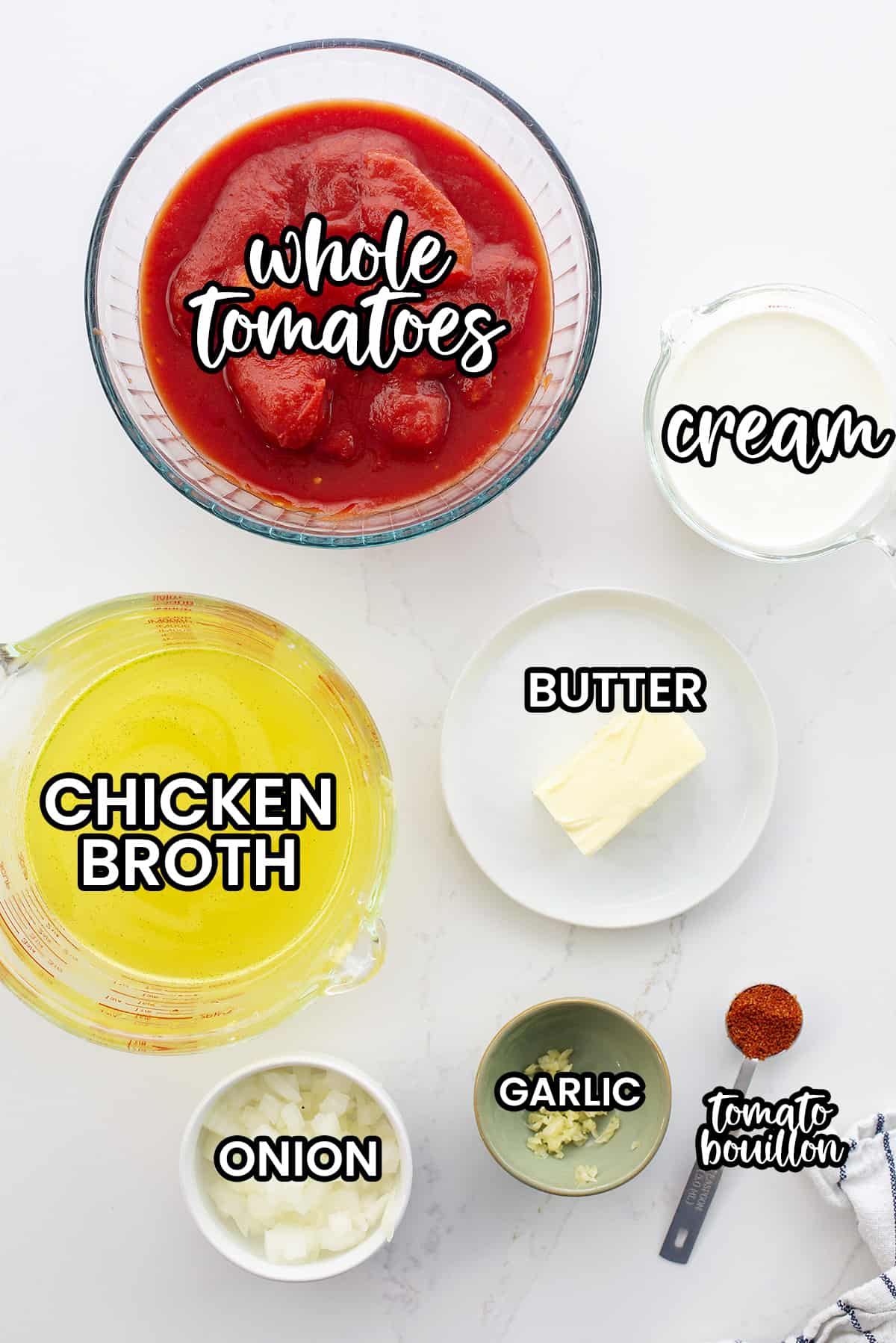 Ingredients for keto tomato soup on white counter.