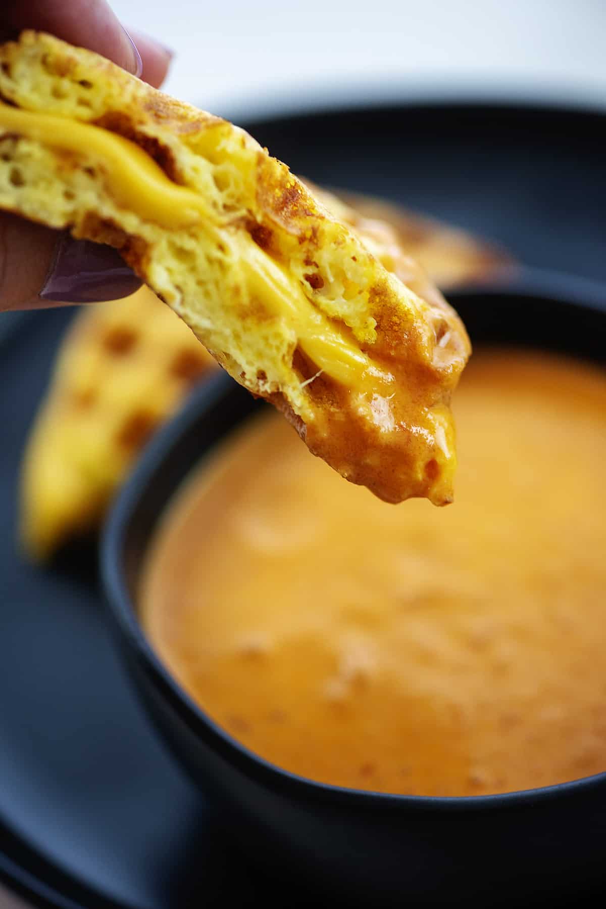 Grilled cheese chaffle dipped in tomato soup.