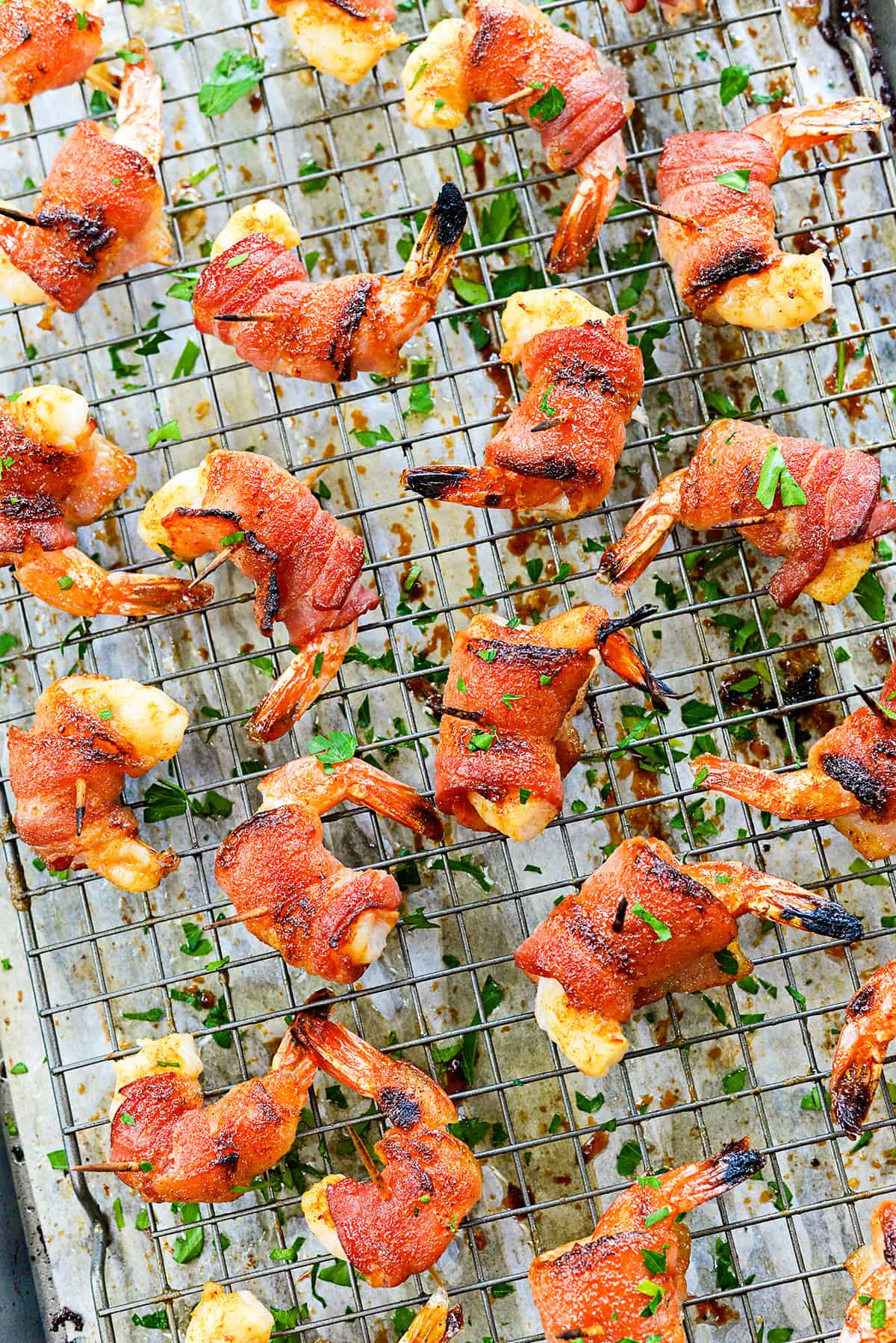 Pan full of bacon wrapped shrimp.