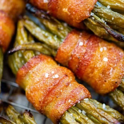 Bacon wrapped green bean bundles piled together.