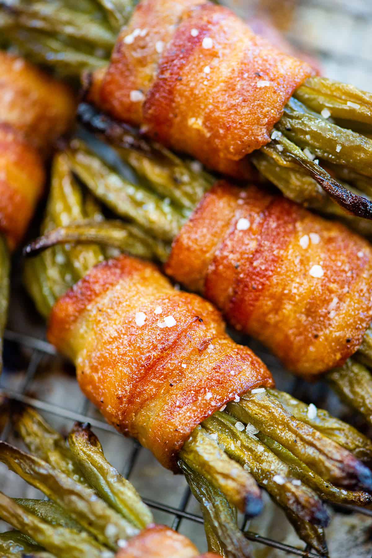 Bacon wrapped green bean bundles piled together.