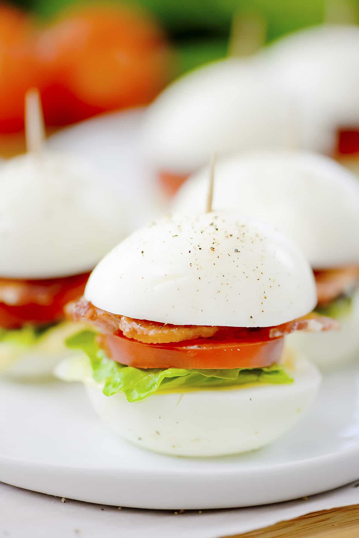 BLT boiled eggs on white plate.