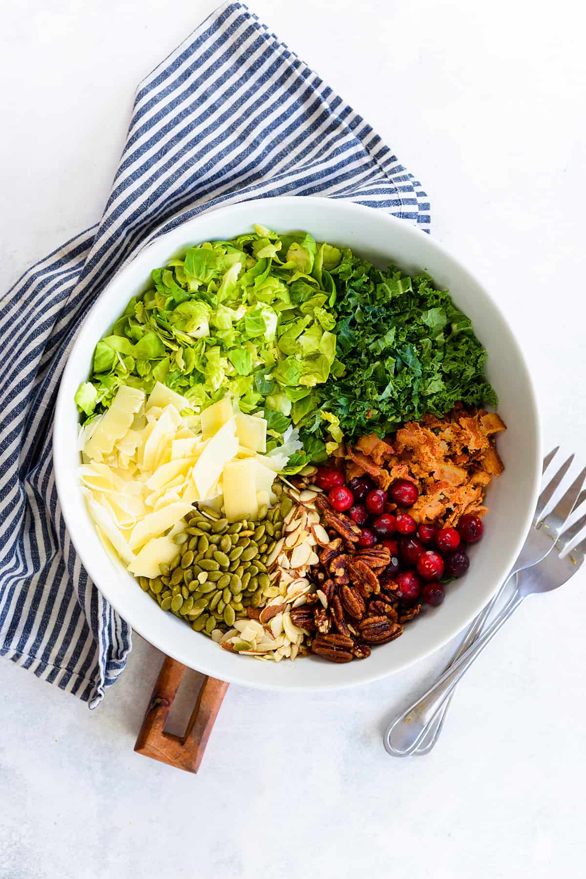 Brussels sprout salad ingredients in bowl.