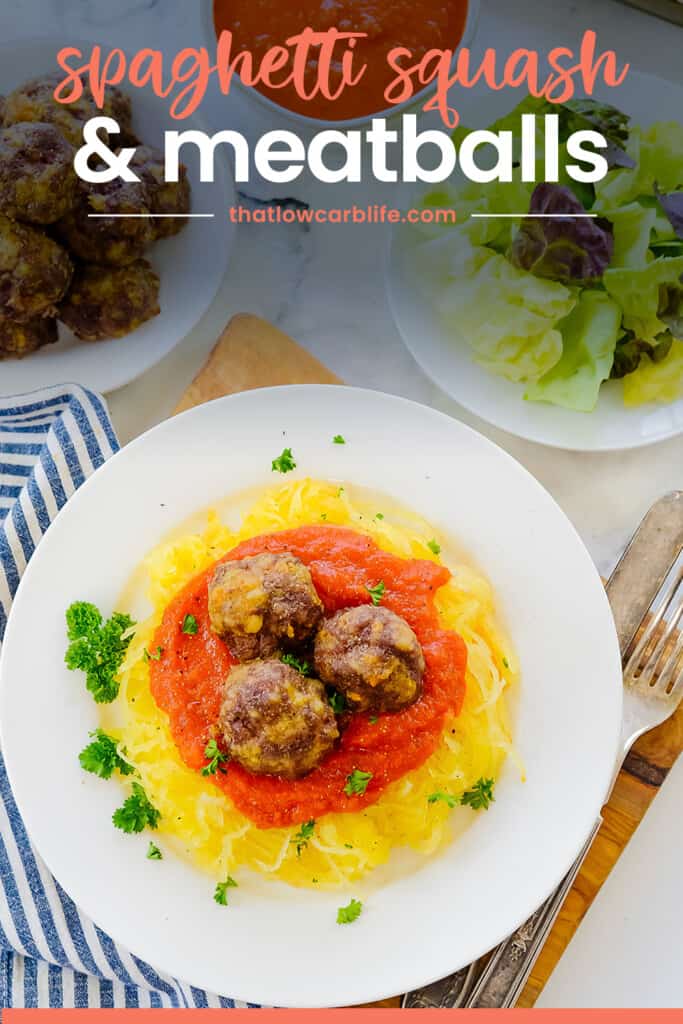 Overhead view of spaghetti squash topped with marinara and meatballs.