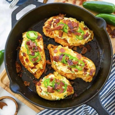 Smothered jalapeno popper chicken in cast iron skillet.