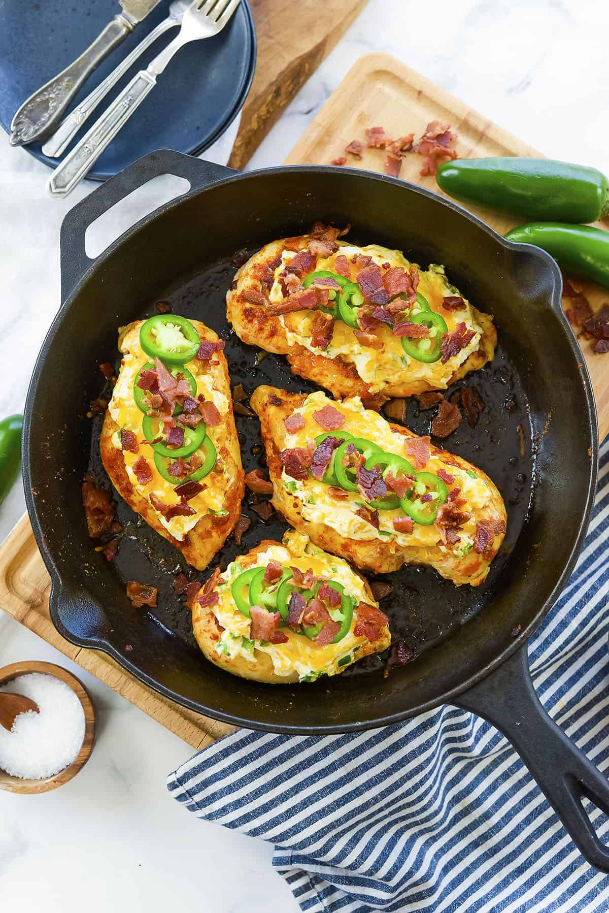 Smothered jalapeno popper chicken in cast iron skillet.