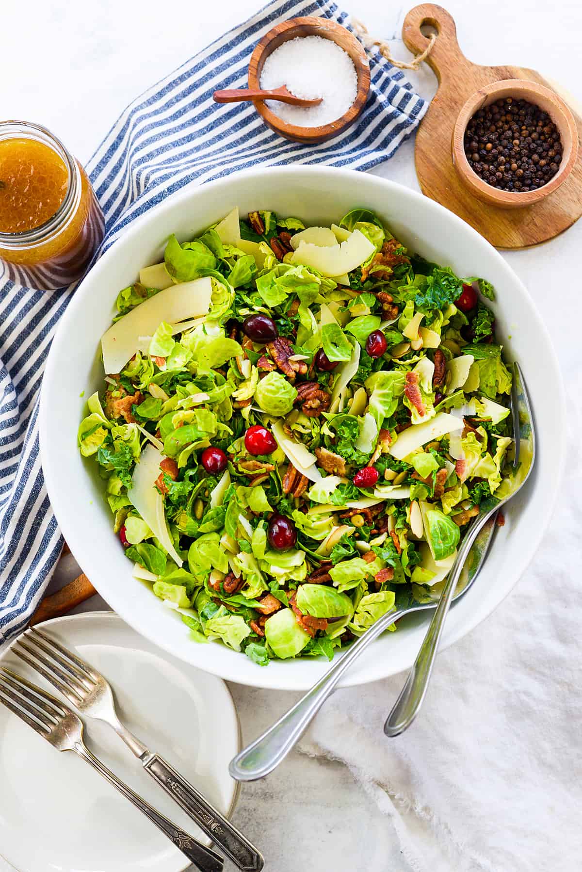 Overhead view of Brussel sprout salad in white bowl.