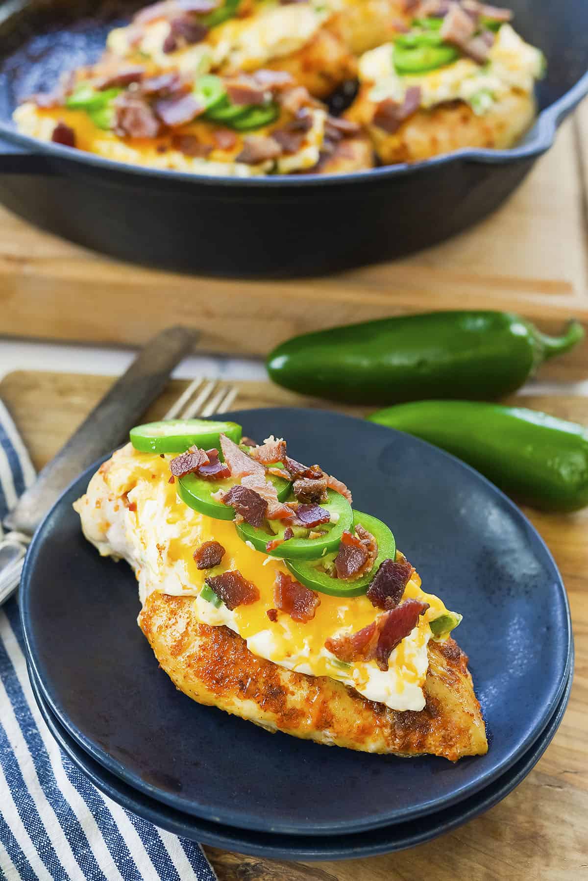 Jalapeno popper chicken on black plate.