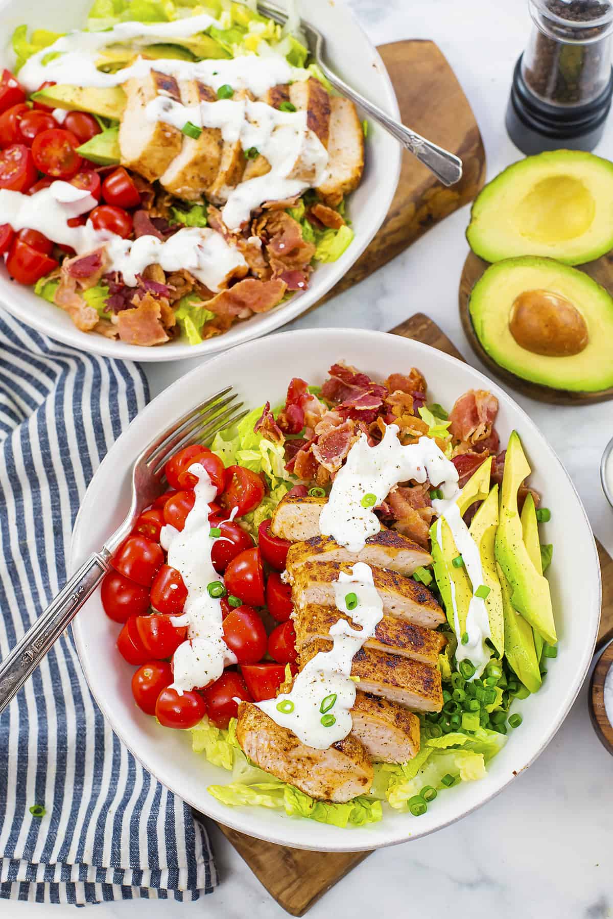 Overhead view of BLT salad with sliced chicken.