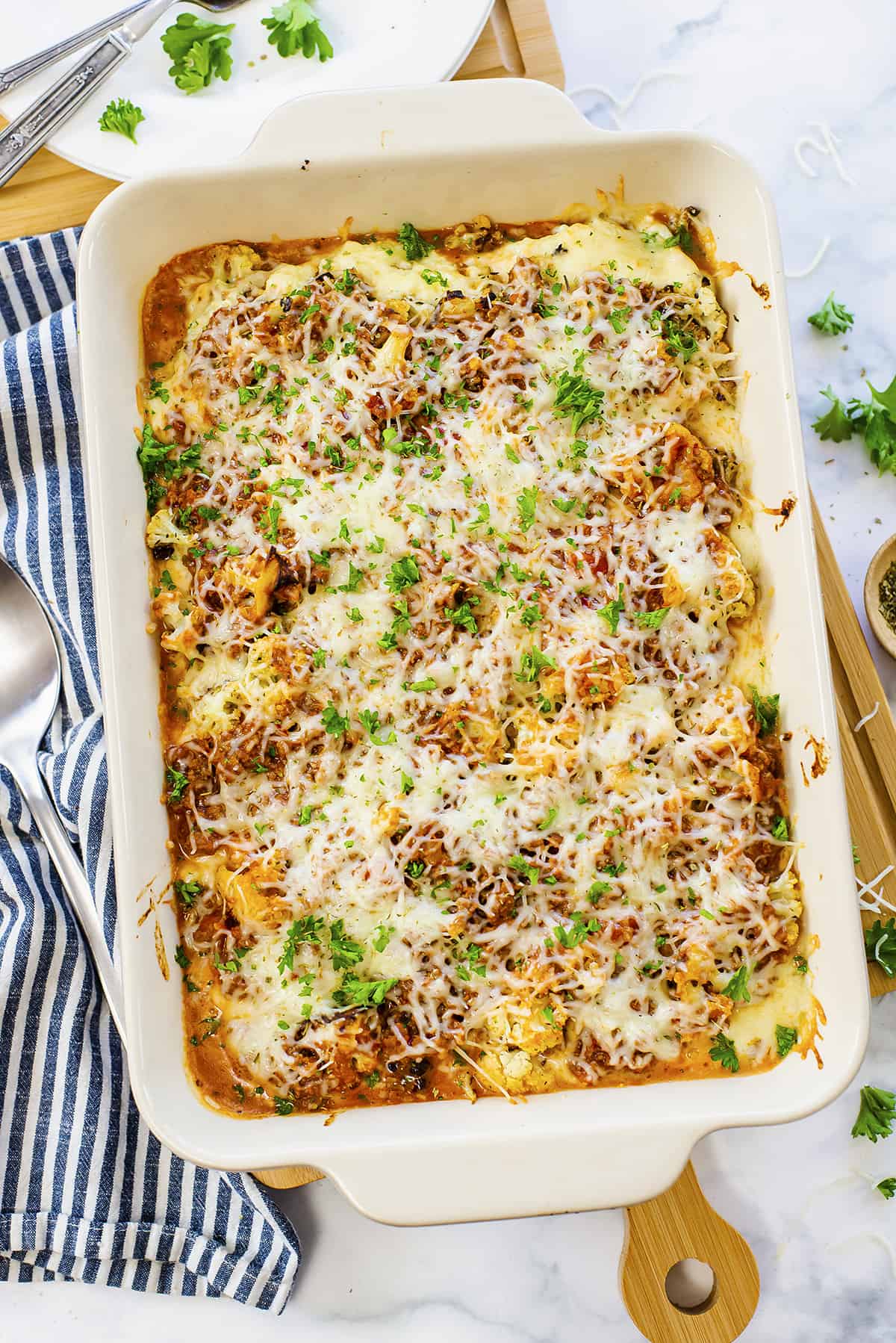 Overhead view of caulifloer baked ziti in white baking dish.