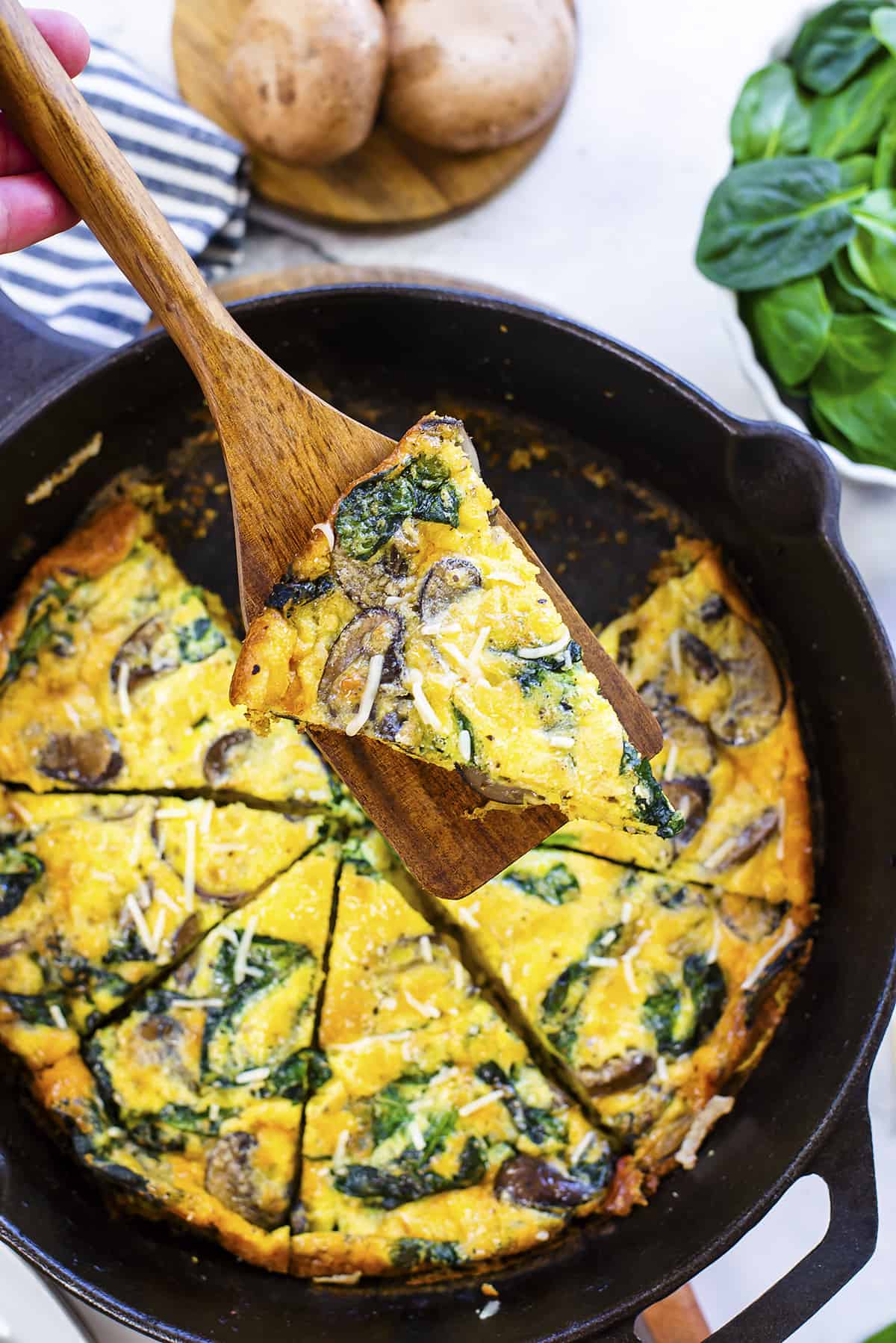 Slice of mushroom frittata on spatula.