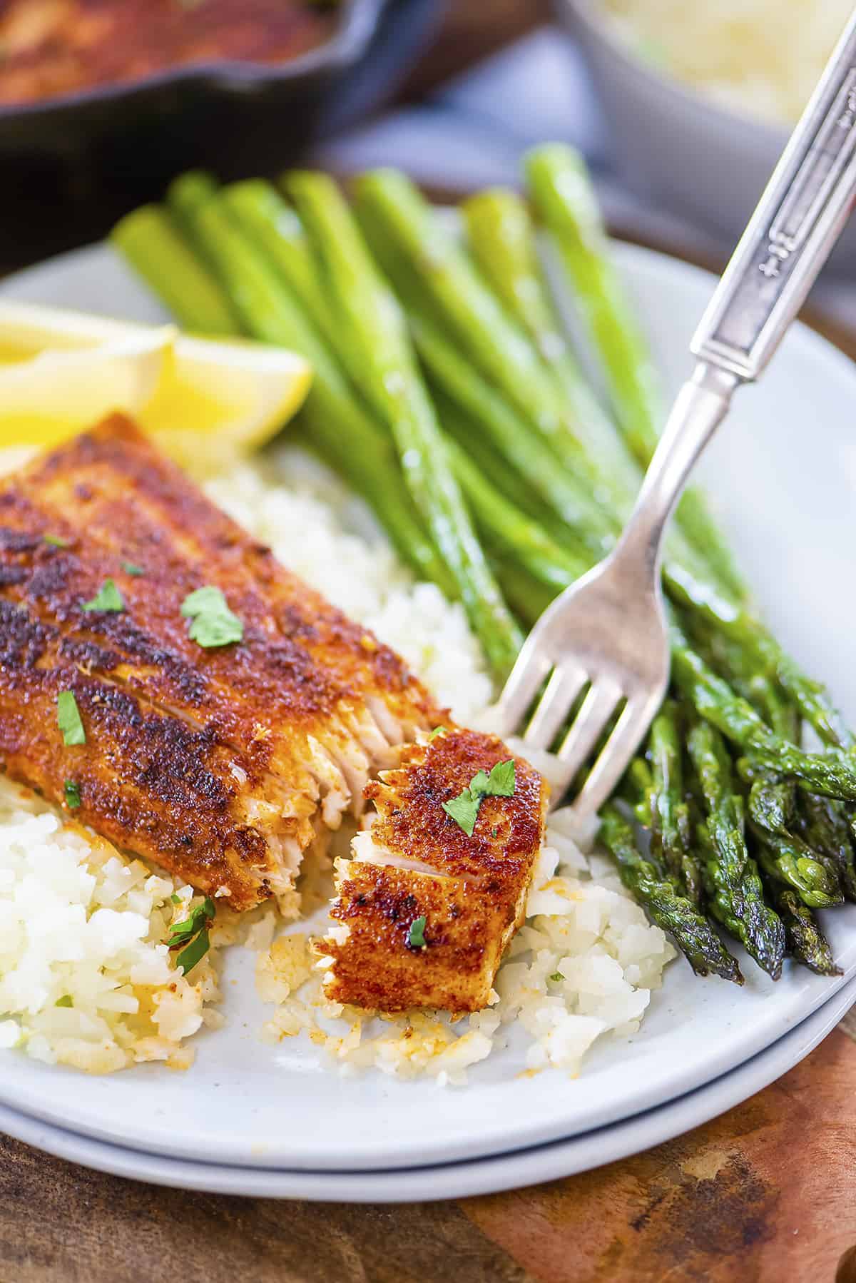 Fork taking a piece of mahi mahi.