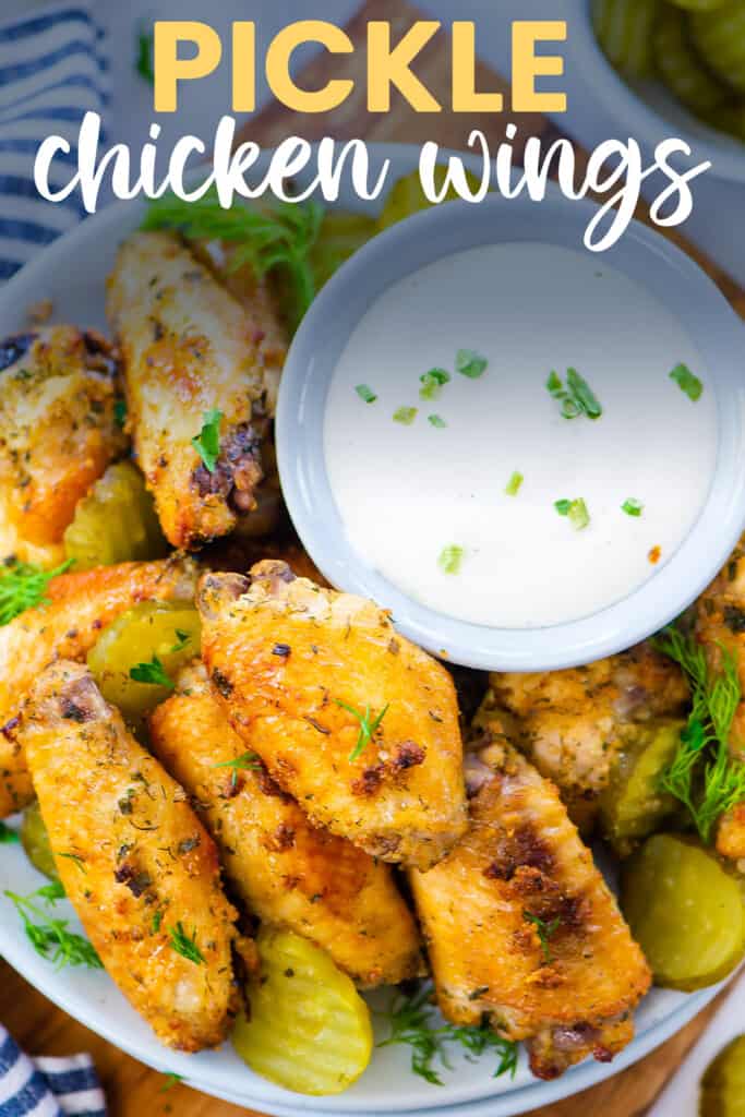 Dill pickle chicken wings in bowl with ranch dressing.