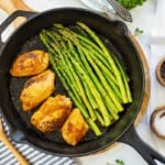 Skillet full of chicken and asparagus.