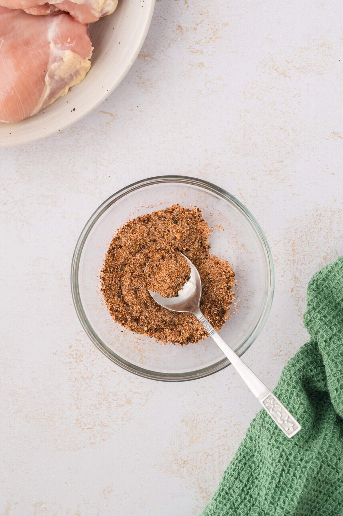 Seasoning blend for chicken in glass bowl.