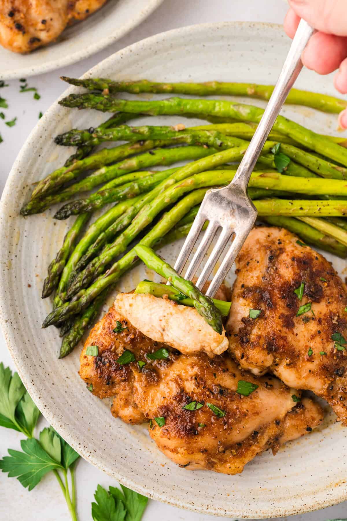 Chicken and asparagus on a fork.