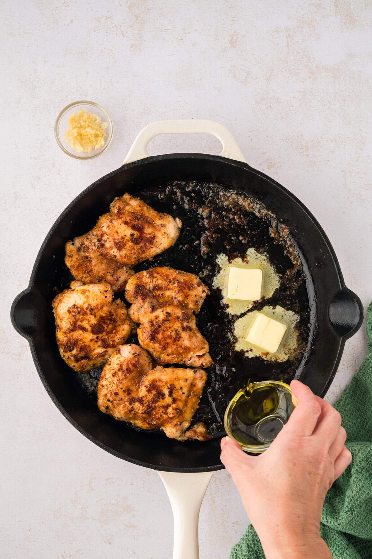 Butter and oil in skillet with chicken.