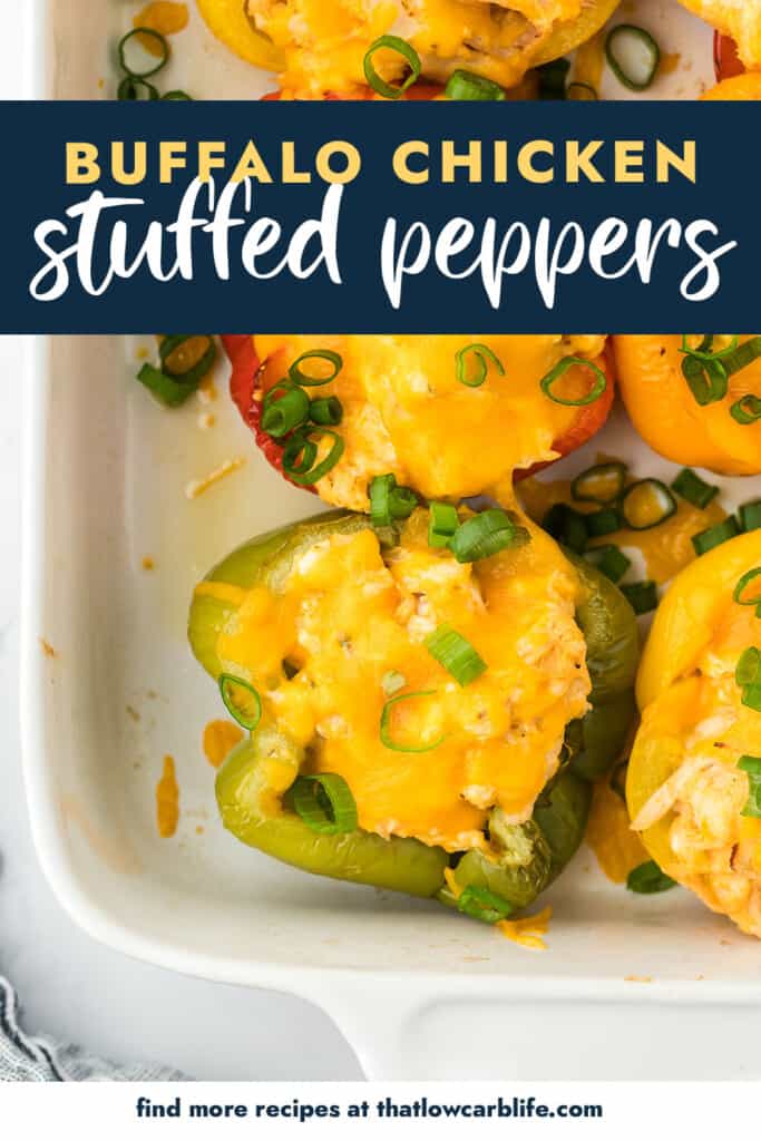 Cheesy stuffed peppers in white baking dish.