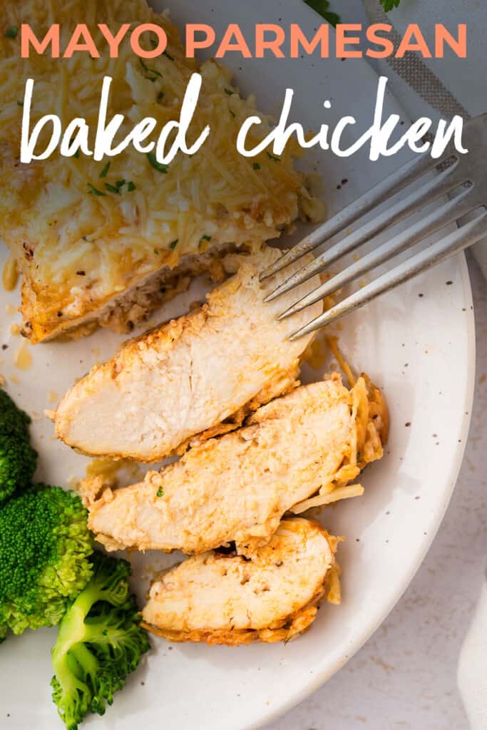 Sliced chicken on white plate.This Mayo Parmesan Chicken bakes up into the most tender, juicy chicken with a savory, crispy, cheesy crust! With just a handful of ingredients that you probably have on hand, this makes the BEST baked chicken breasts!