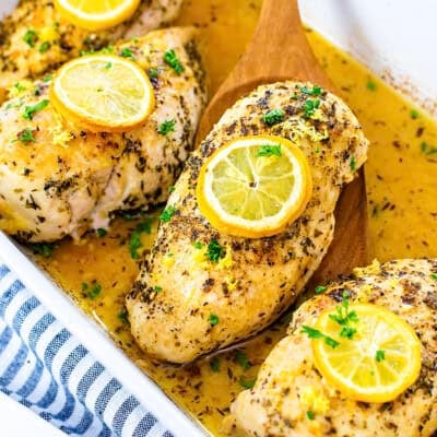 Lemon butter chicken in white baking dish.