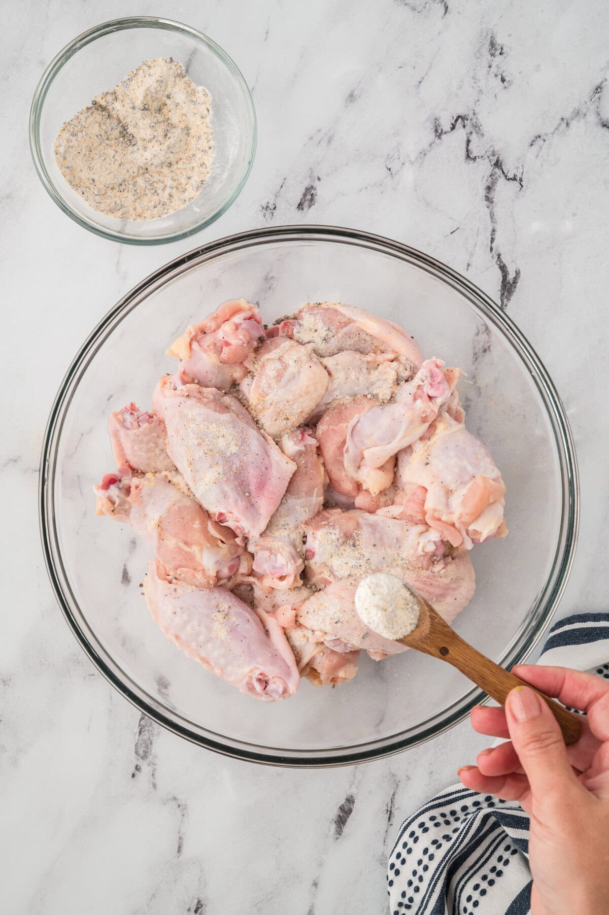 Wings being coated in seasoning.
