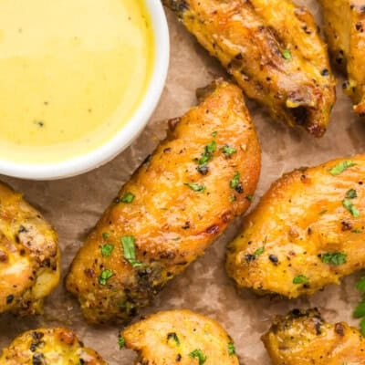 Honey mustard wings on pan with sauce.