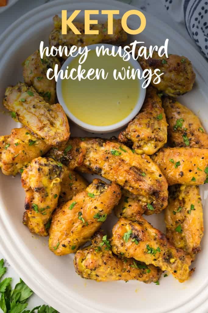Keto honey mustard wings on serving platter with dish of honey mustard sauce for dipping.
