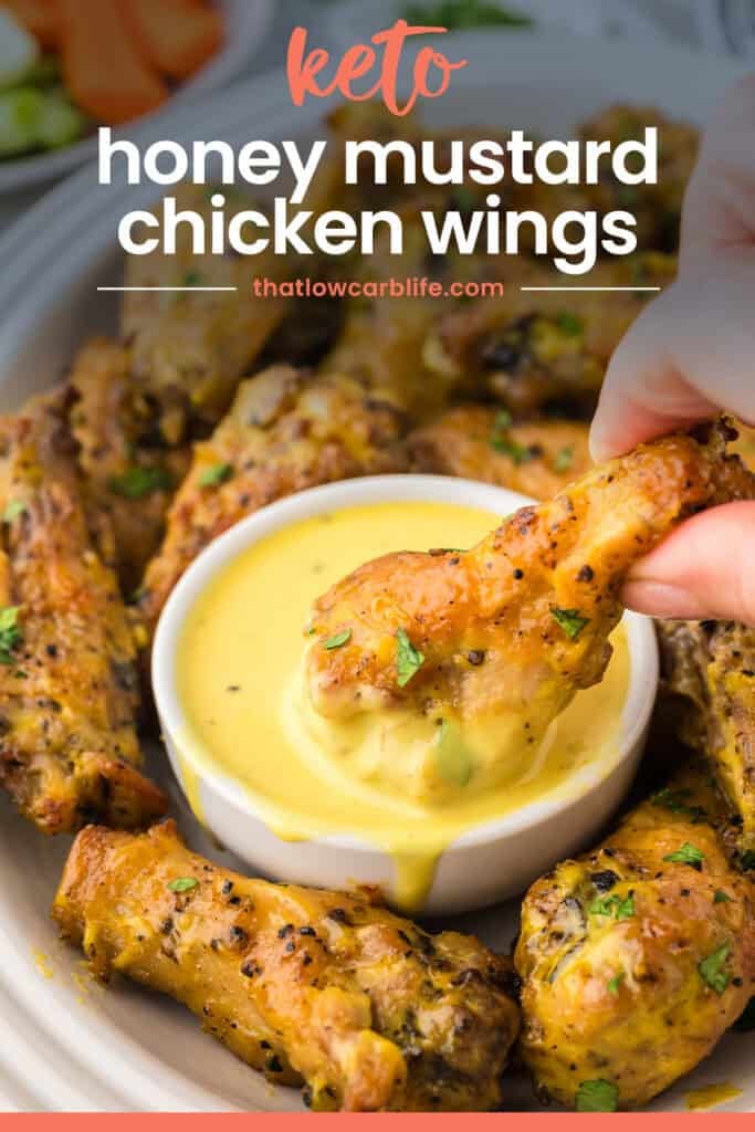 Wings being dipped in honey mustard.